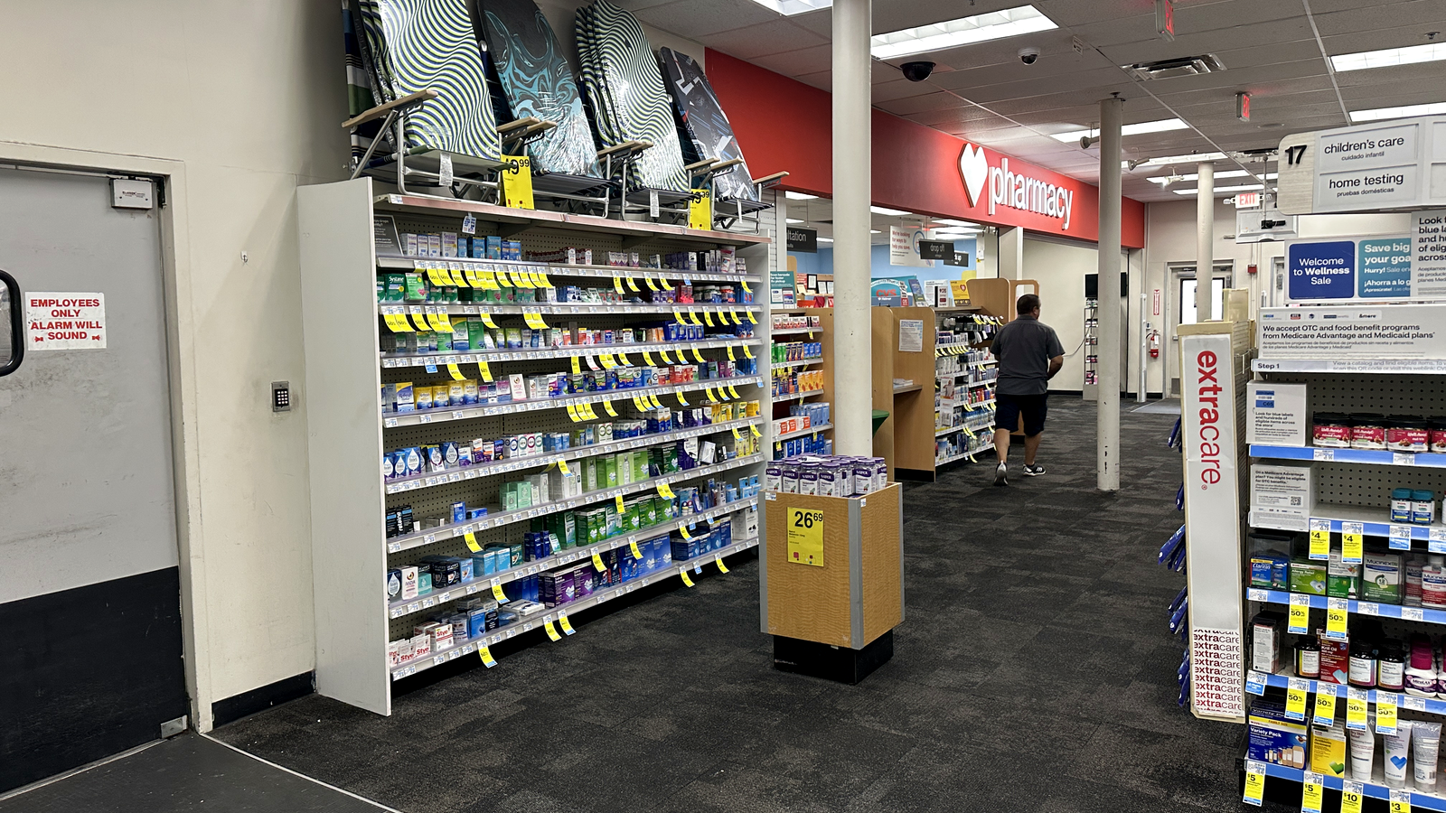 Interior of a CVS store in Miami Beach in July 2025, showing pharmacy signage, shelves and yellow sale tags.