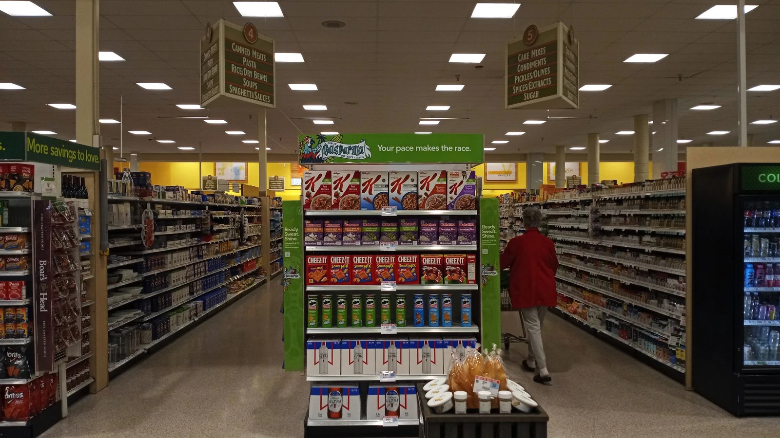 Interior aisle of a Publix store, where the weekly ad has to be matched against the shelf item, size and quantity.